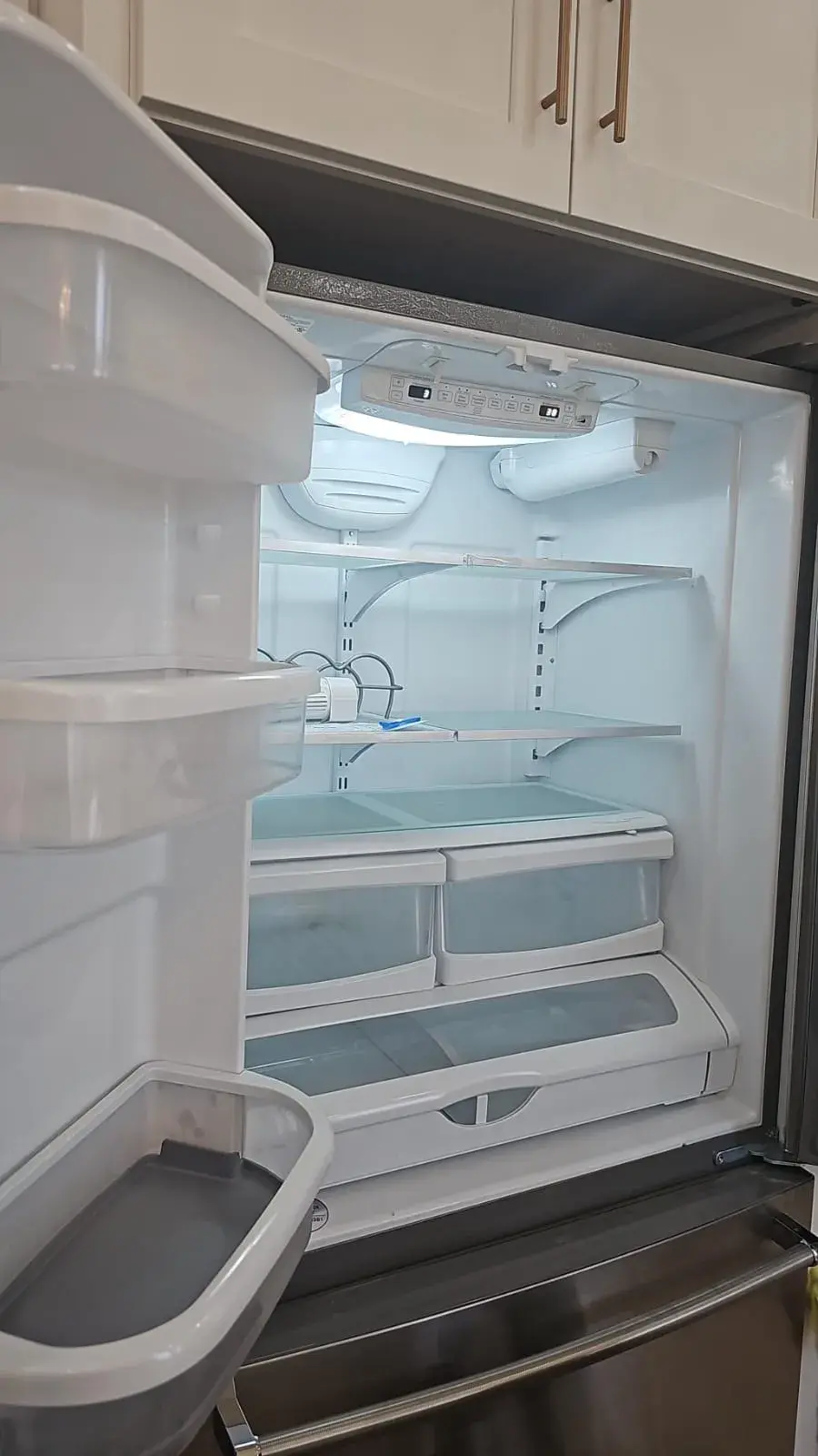 Clean and empty refrigerator interior with shelves and drawers ready for use